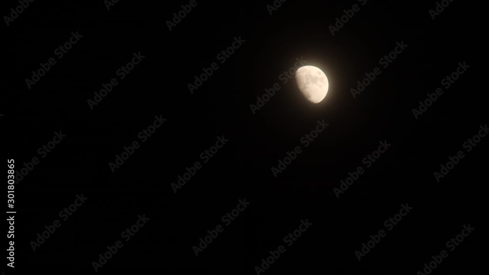 Hyperlapse of moon`s rising through clouds in dark night Hyperlapse of moon`s rising through clouds in dark night