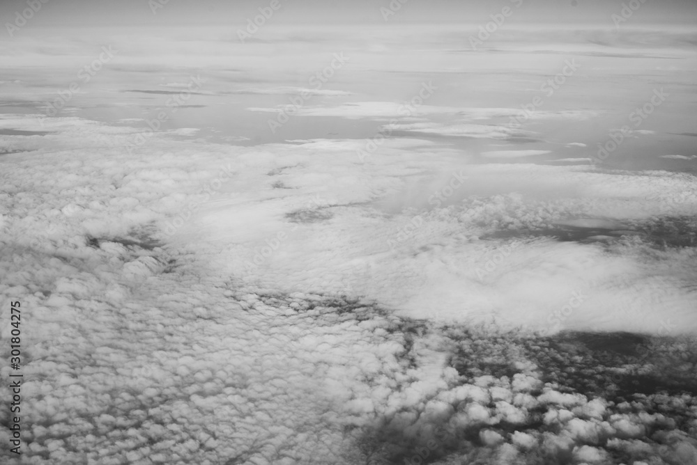 White fluffy clouds top view from the airplane window. Abstract background