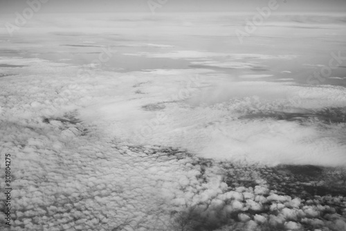 White fluffy clouds top view from the airplane window. Abstract background © Lazy_Bear