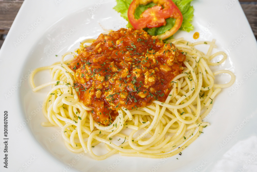 A portion of Italian spaghetti in white plate A portion of Italian spaghetti in white plate