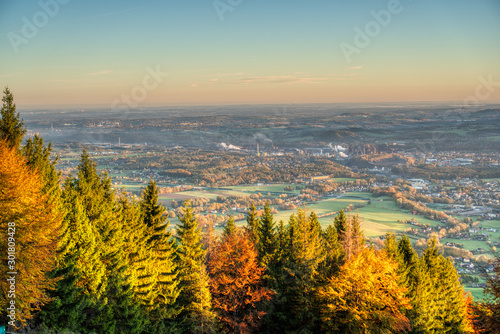 view of a valley full of industry that smokes and house from the mountain at sunrise in autumn