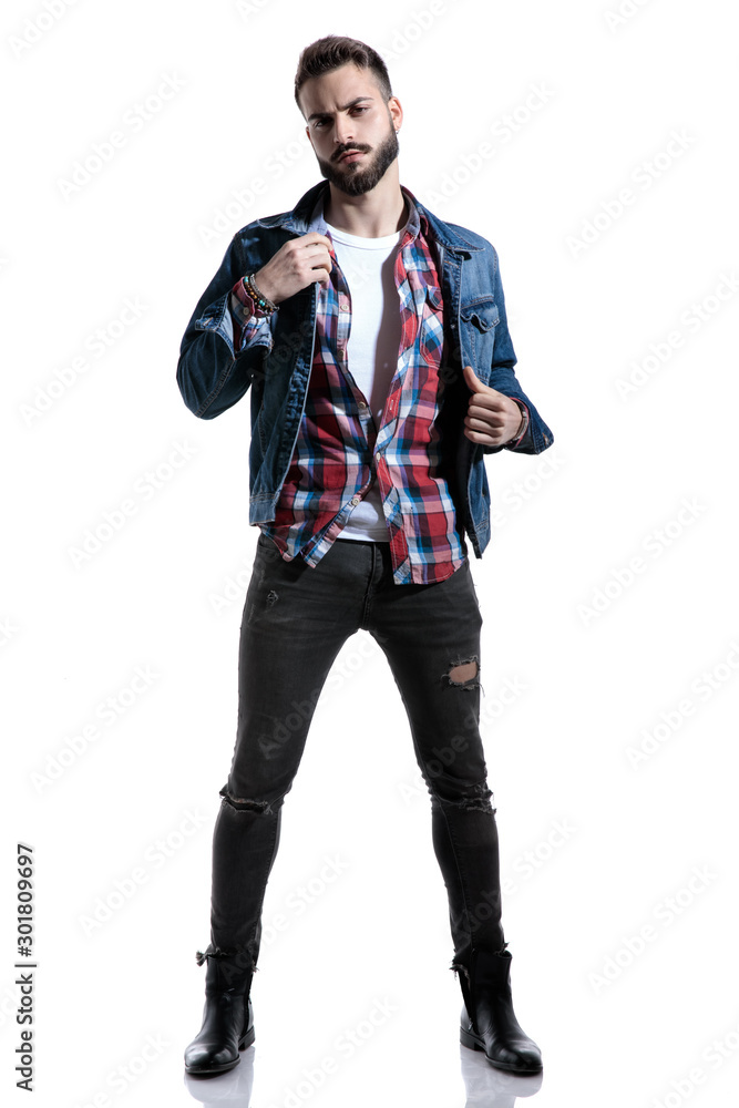 dramatic fashion model posing and holding jeans jacket dramatic fashion model posing and holding jeans jacket