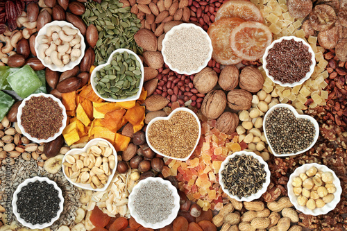 Dried fruit nut and seed collection forming a background. Health food high in antioxidants, protein, omega 3. minerals, vitamins and anthocyanins. Flat lay.