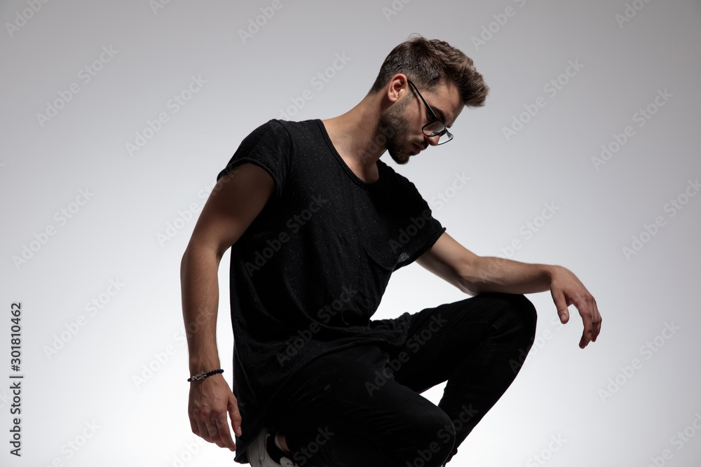 sexy fashion man dressed casual wearing glasses and posing sexy fashion man dressed casual wearing glasses and posing