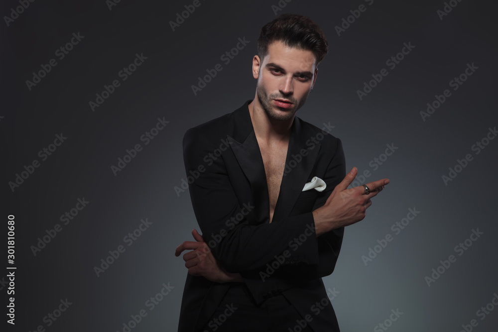 cool fashion guy holding hand in a fashion pose