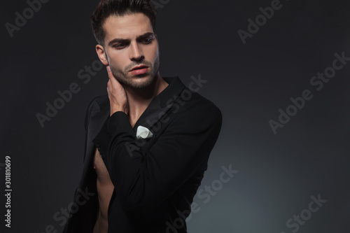 dramatic cool guy holding hand behind neck in a fashion pose