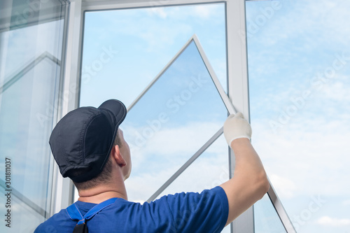 Obraz na plátne window wizard inserts mosquito net into the finished window
