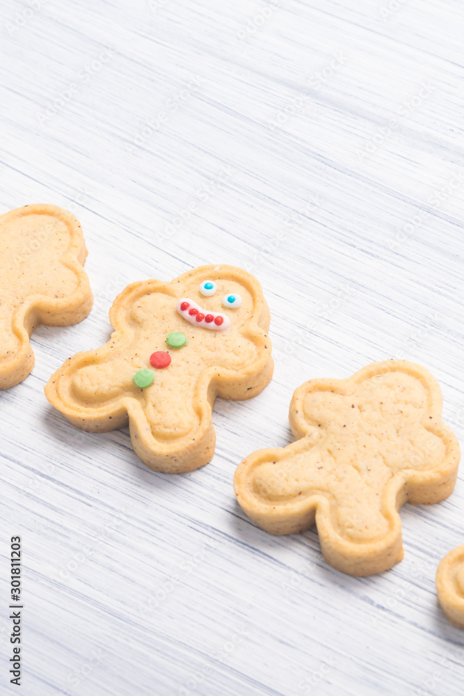 cookies in the shape of a man on a light table background, close-up cookies in the shape of a man on a light table background, close-up