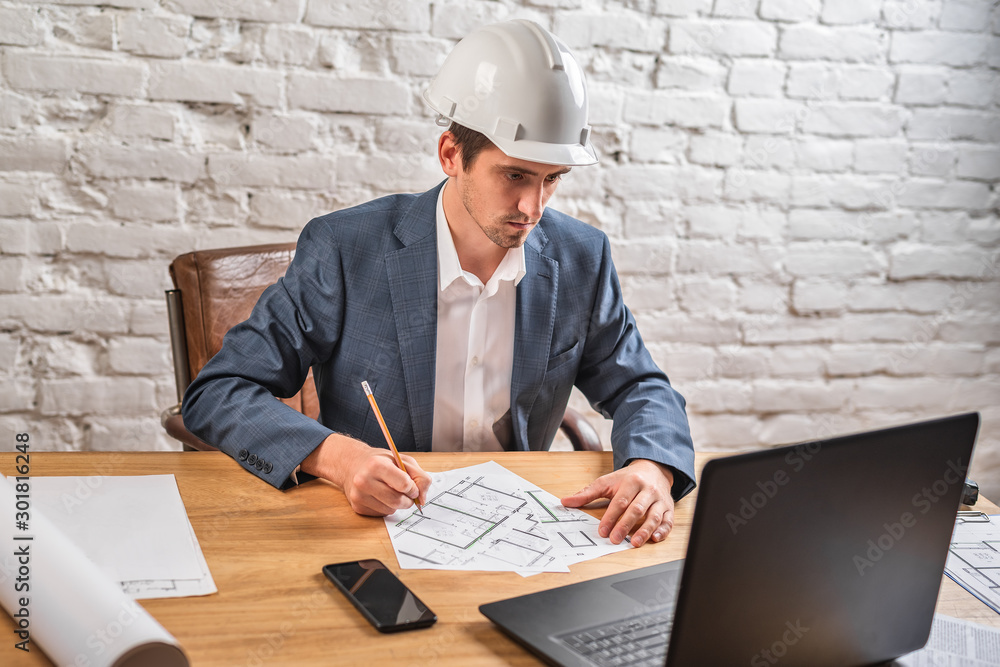 civil engineer at his Desk working with documents civil engineer at his Desk working with documents