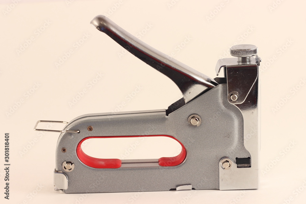 New furniture stapler gun closeup on white background New furniture stapler gun closeup on white background