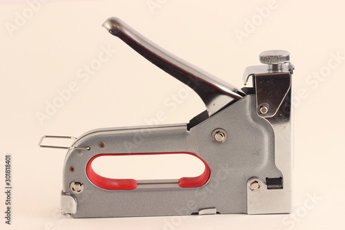 New furniture stapler gun closeup on white background
