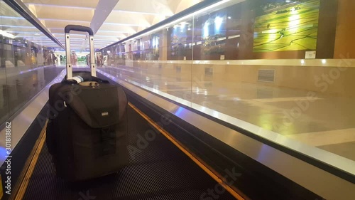 A lonely handluggage suitcase on the treadmill of an airport in Taiwan photo