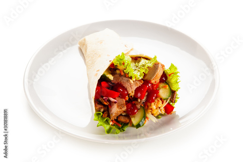 Kebab - grilled meat and vegetables wrapped in tortilla
