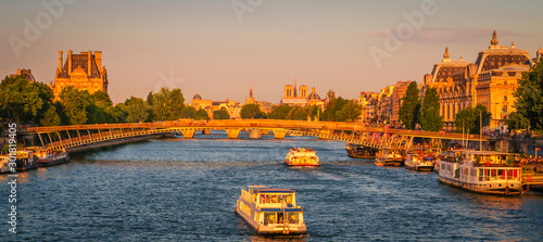 Sunset view on bridge Passerelle Leopold Sedar Senghor and buildings on the Seine river in Paris, France photo
