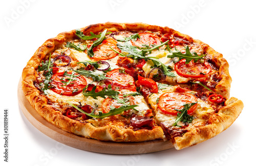 Vászonkép Pizza with ham, rucola, and vegetables on white background