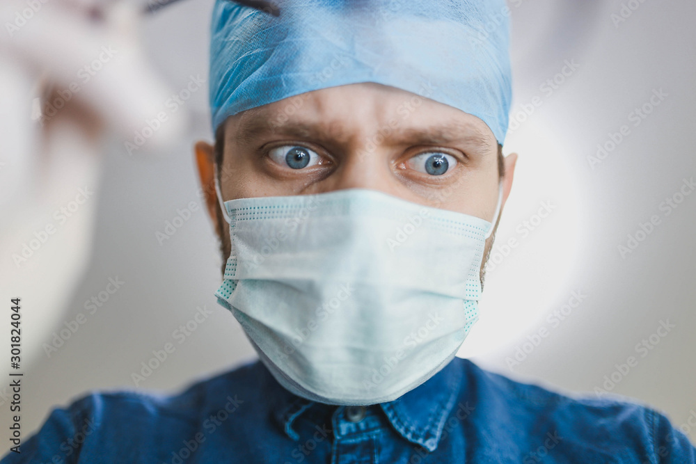 bottom view of a young surgeon looking at camera. Surgical operation in the hospital. bottom view of a young surgeon looking at camera. Surgical operation in the hospital.
