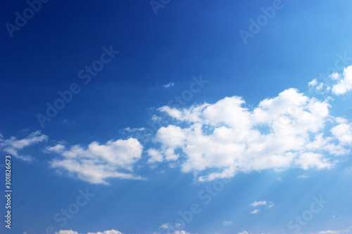 Blue sky with white clouds background. Fantastic soft white clouds against the blue sky.