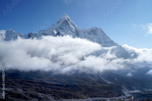 Ama Dablam 6814m clouds covered peak View near Dingboche settlement in Sagarmatha National Park, Nepal. Everest Base Camp (EBC) trekking route. © Train arrival