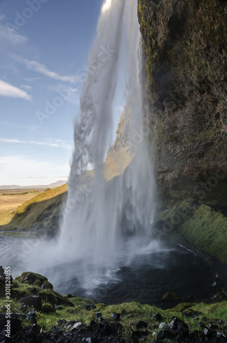 amazing Seljalandfoss waterfall in sunny autumn day  Iceland. Famous tourist attraction