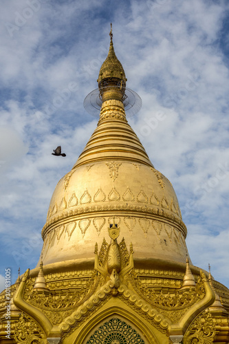 A bird flies over Sule pegoda, Yangon, Myanmar.