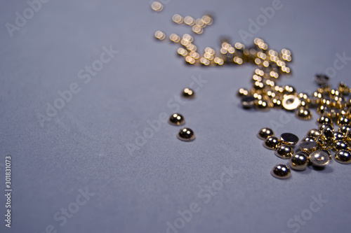 Gold glitter lined with zigzag with blur. Gray background, top view, place for text. Festive minimalism