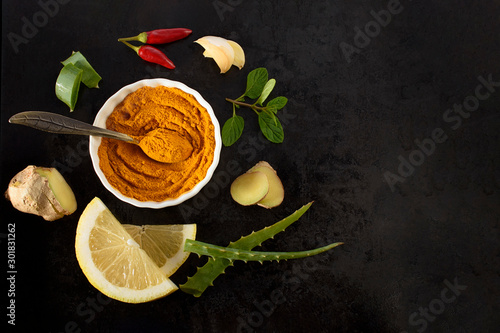 Natural ingredients for colds and flu care on a white background: red pepper, garlic, ginger, aloe vera, lemon, turmeric