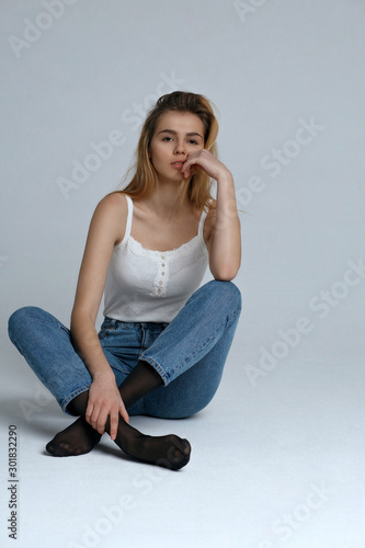 Tender girl wears casual outfit posing at studio