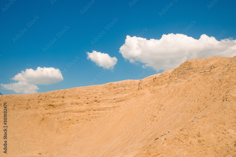 Sand mountain against the blue sky