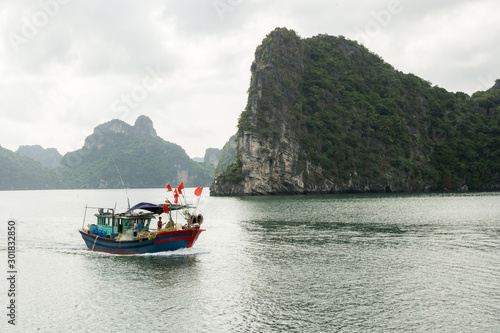 Fishing boats among the islands that make up Ha Long Bay, Vietnam.