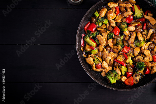 Stir fry with chicken, mushrooms, broccoli and peppers. Chinese food. Top view, overhead photo