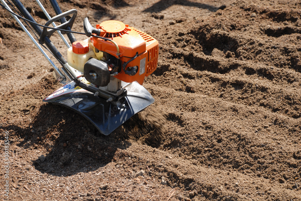 small engine rotatillar tilling a garden, hand tilling a garden small engine rotatillar tilling a garden, hand tilling a garden