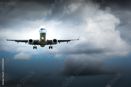 Fototapeta Naklejka Na Ścianę i Meble -  Jet airplane flying in the cloudy skies