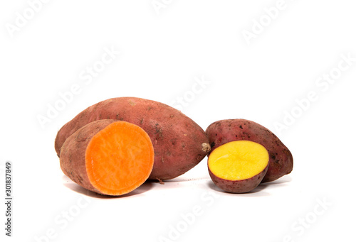 Sweet potatoes and red potatoes isolated on a white background. The concept of eating sweet potatoes instead of potatoes. An interesting alternative to potatoes.