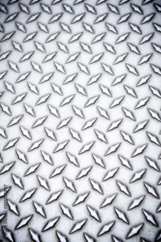 Detail close-up view of shiny steel diamond plate industrial background Detail close-up view of shiny steel diamond plate industrial background