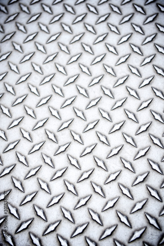 Detail close-up view of shiny steel diamond plate industrial background © PeskyMonkey