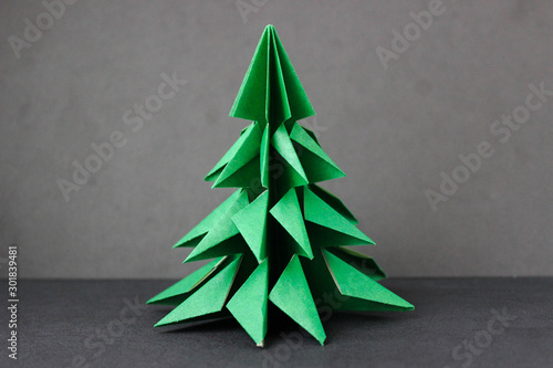 Origami green tree on a black background