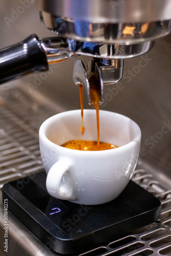 Closeup image of prepears coffee in a coffeeshop using professional coffeemachine.