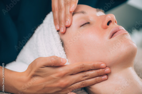 Woman Receiving Facial Fitness Lifting Massage photo