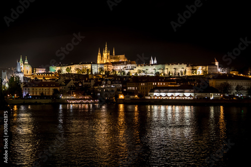 Illuminated Saint Vitus Cathedral  Hradcany Castle And River Moldova In The Night In Prague In The Czech Republic
