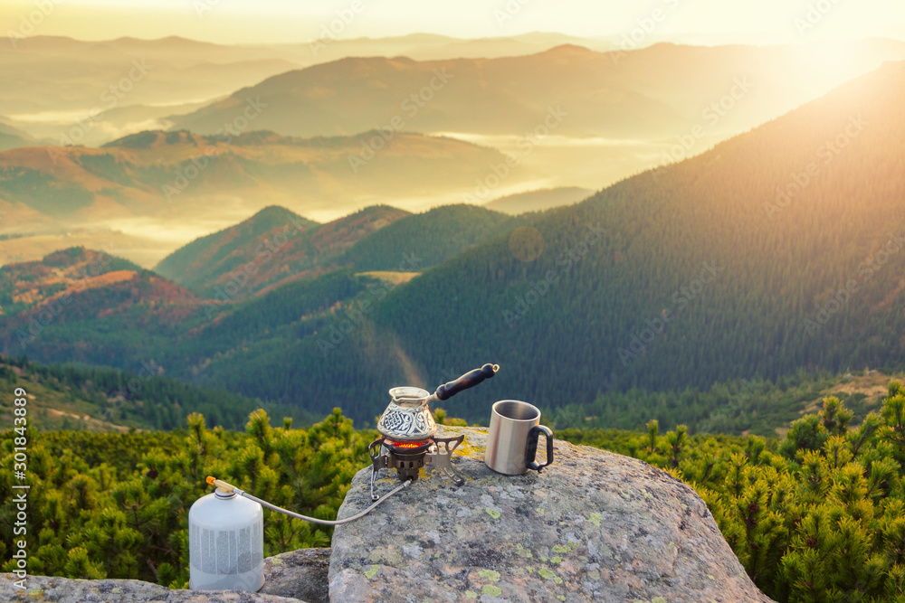 Hot morning coffee high in the mountains. - obrazy, fototapety, plakaty 