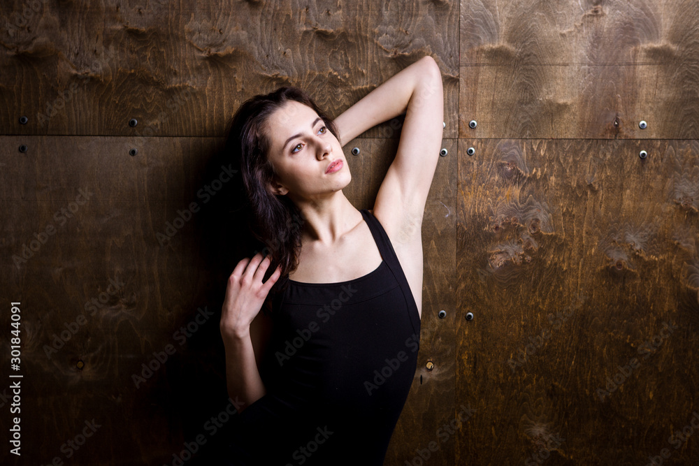 Young woman dancer. Young woman modern dance. Skill ballet dancer posing. dancer posing near the wall. full length portrait of a flexible young woman posing near the wall. Dancer, flexibility
