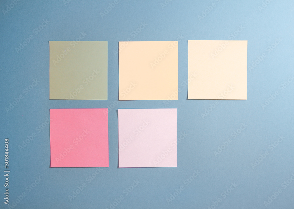 5 blank empty white and pastel colors sticky notes on clean blue background with free space, from top view with copy space 5 blank empty white and pastel colors sticky notes on clean blue background with free space, from top view with copy space