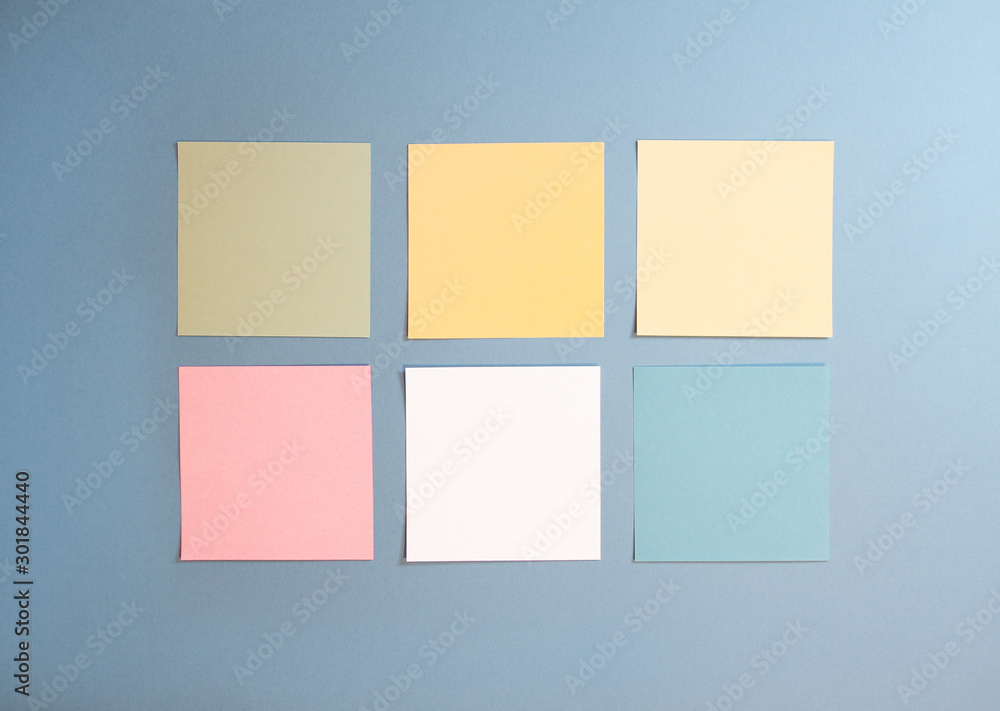 6 blank empty white and pastel colors sticky notes on clean blue background with free space, from top view with copy space 6 blank empty white and pastel colors sticky notes on clean blue background with free space, from top view with copy space