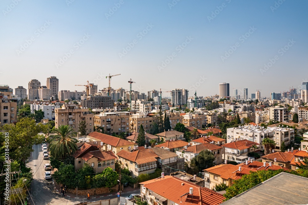 Givatayim, Tel Aviv Israel. Givatayim and Tel Aviv skyline in early morning. View to the city from Givataim hills. Old houses and new modern skyscrapers.