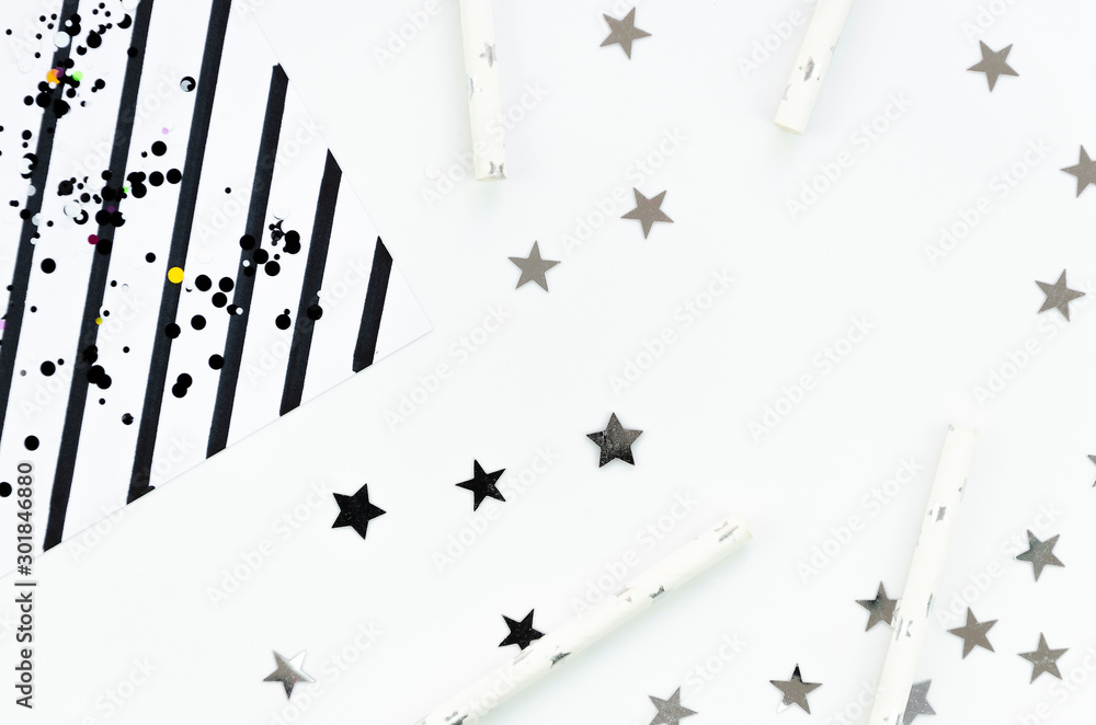 Naklejka premium New Year or Christmas geometric black and white pattern flat lay top view 2020 celebration drinking cocktail party straws, stripes and silver star sparkles background