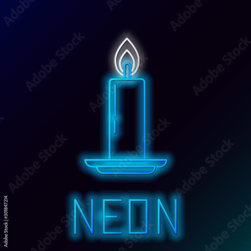 Blue glowing neon line Burning candle in candlestick icon on black background. Old fashioned lit candle. Cylindrical candle stick with burning flame. Colorful outline concept. Vector Illustration