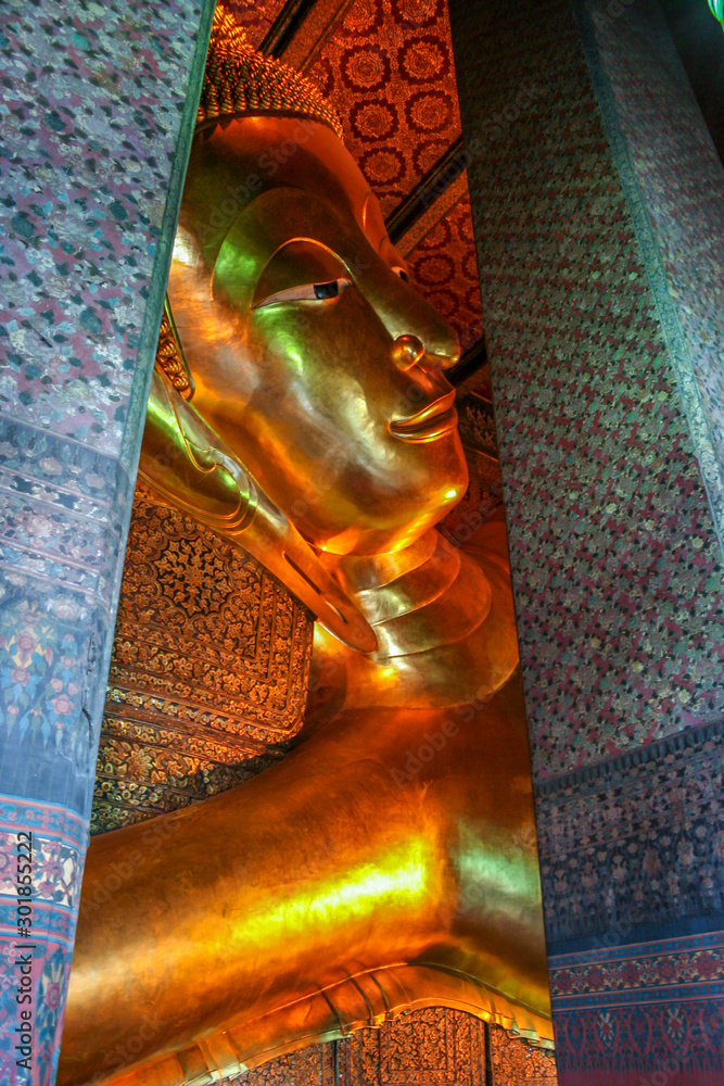 2011.05.14, Bangkok, Thailand. A head of Golden statue in Wat Pho. Interior of the Temple of the Reclining Buddha. Famous sights of Bangkok.