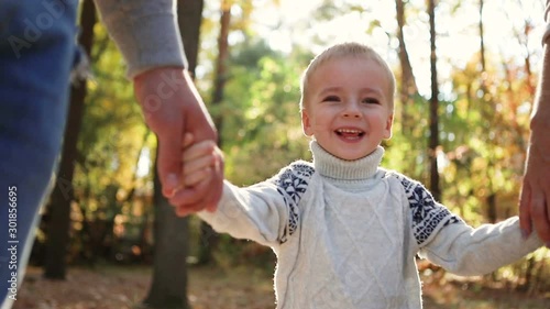 Wallpaper Mural Happy childhood. Mom, dad and little son holding hands. Boy smiling, laughing Torontodigital.ca