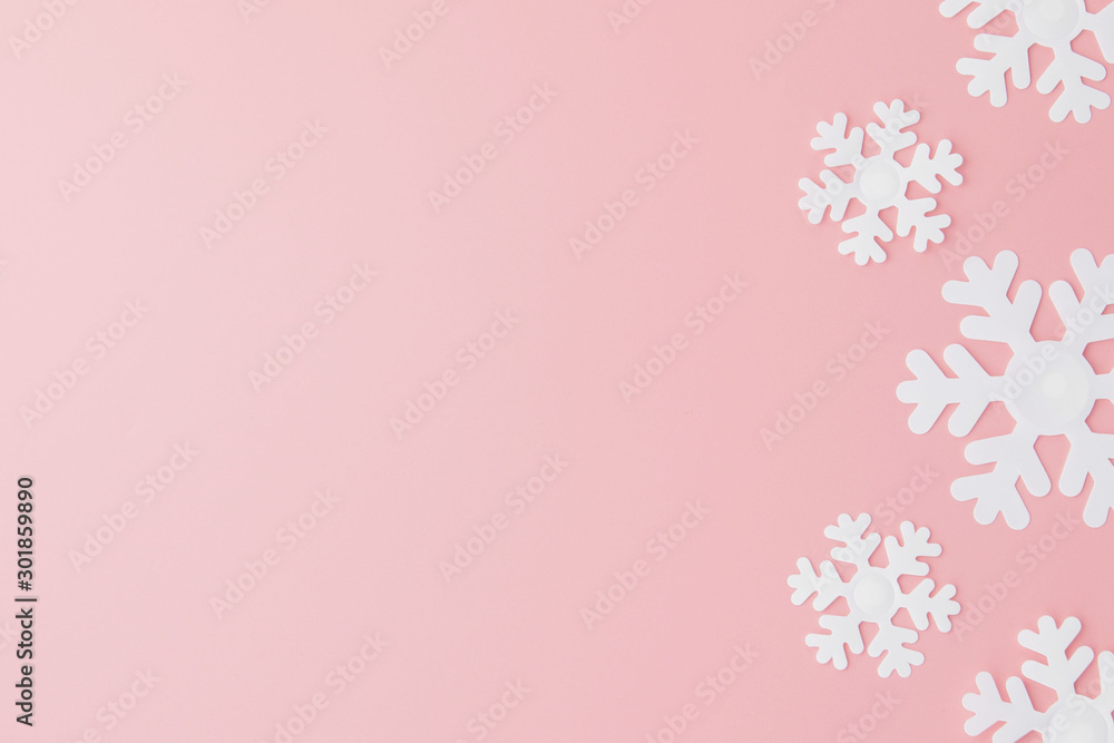 Winter pattern made of snowflakes and on pink background. Christmas concept. Flat lay. Copy space for your text
