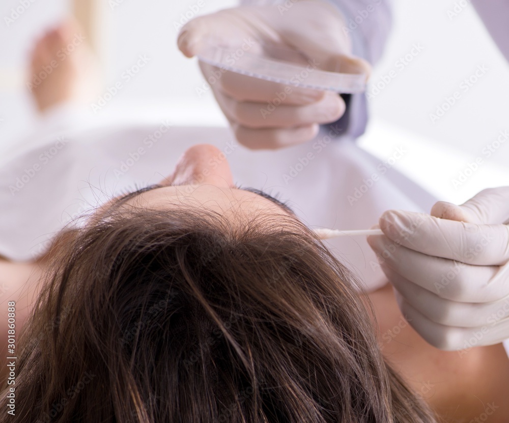 Naklejka premium Police coroner examining dead body corpse in morgue